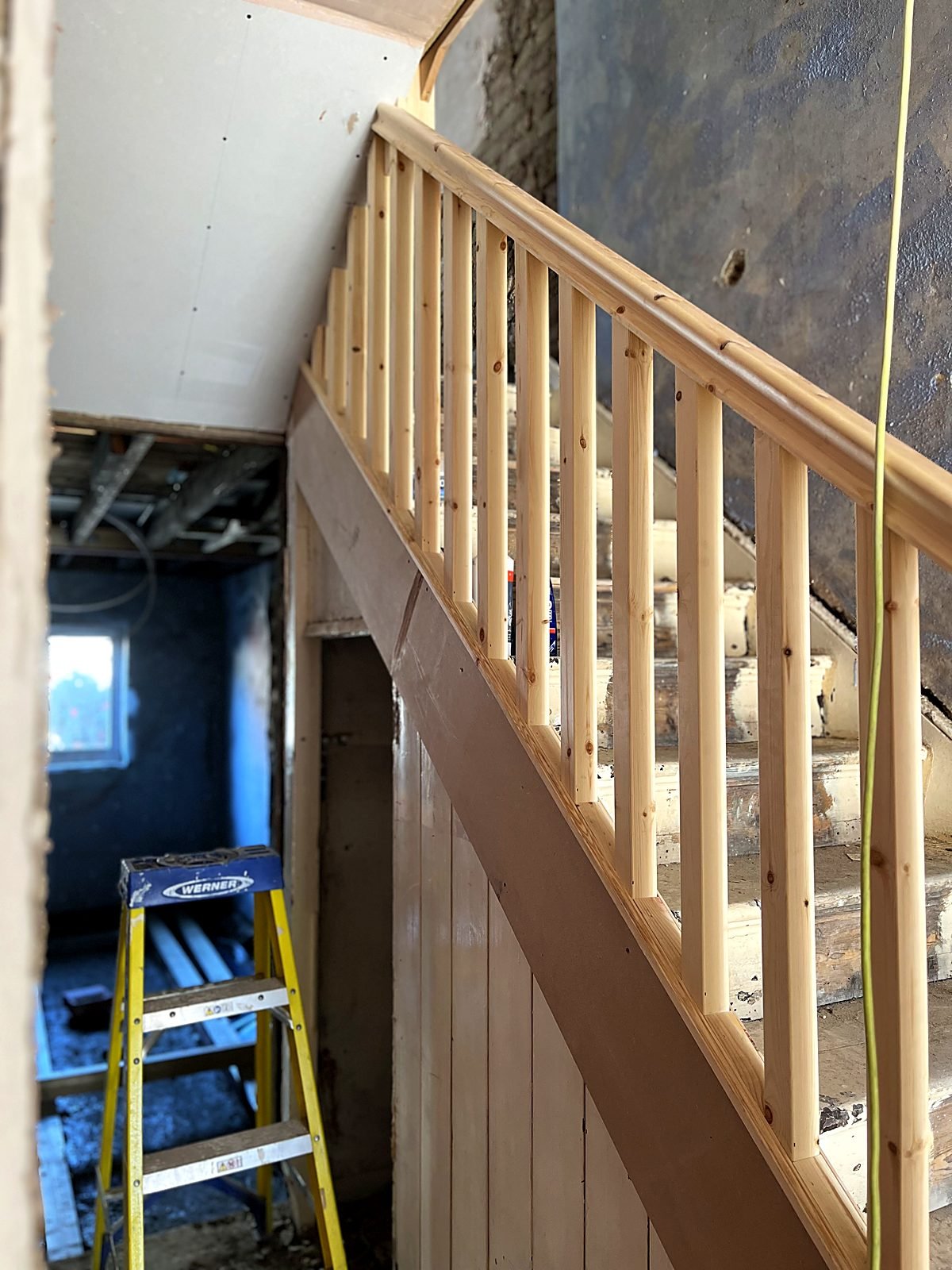 Staircase renovation in progress — new pine handrail, spindles and stringer