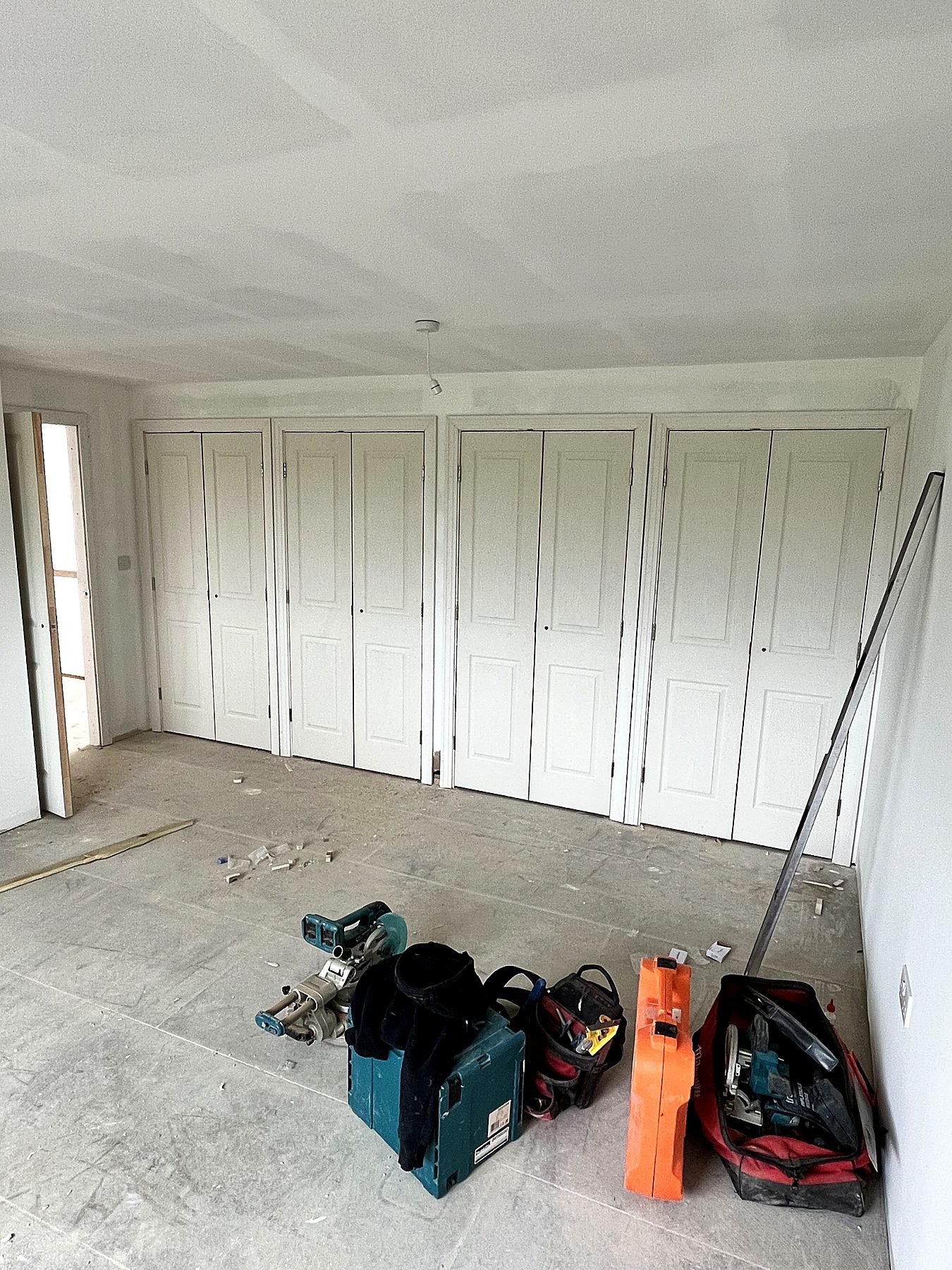 A full wall of fitted wardrobes with panelled double doors